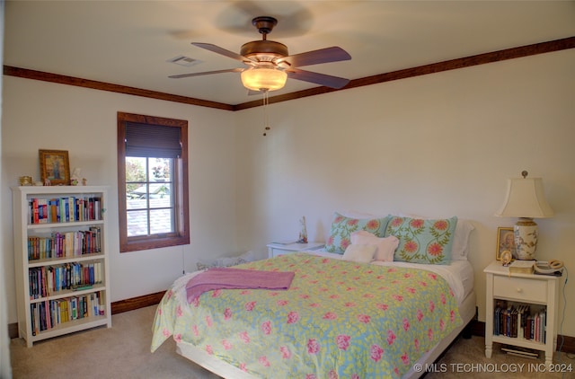 bedroom featuring ceiling fan, crown molding, and carpet