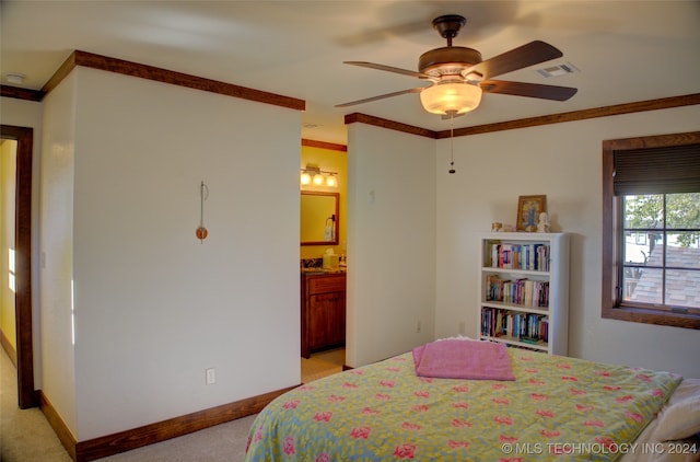 bedroom with crown molding, ceiling fan, ensuite bathroom, and light colored carpet