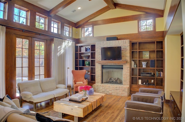 living room featuring a fireplace, plenty of natural light, beamed ceiling, and high vaulted ceiling