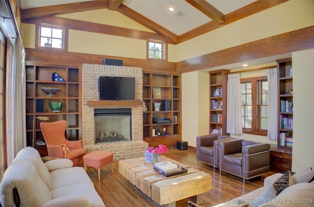 living room with beamed ceiling, wood-type flooring, high vaulted ceiling, and a brick fireplace