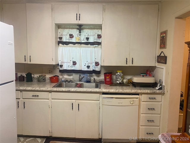 kitchen with white cabinetry, white appliances, sink, and tasteful backsplash