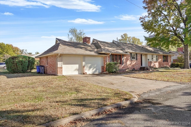 ranch-style house featuring a garage and a front yard