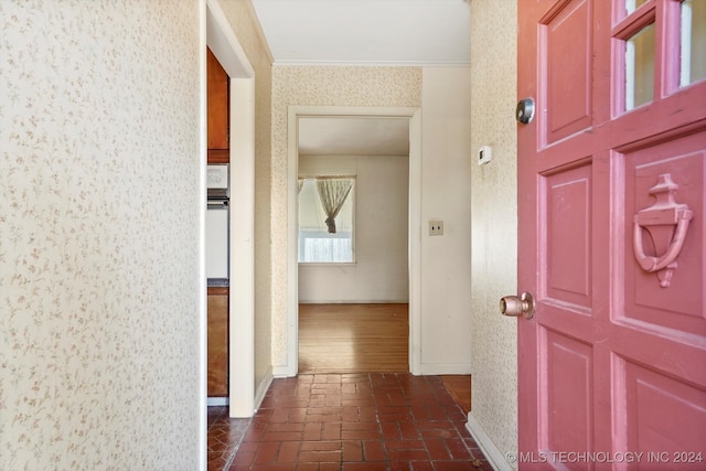 corridor featuring crown molding