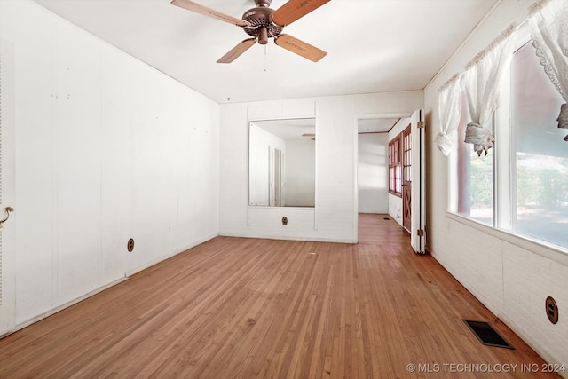 empty room featuring ceiling fan and light wood-type flooring