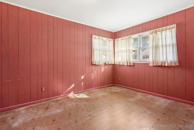 spare room with wood walls