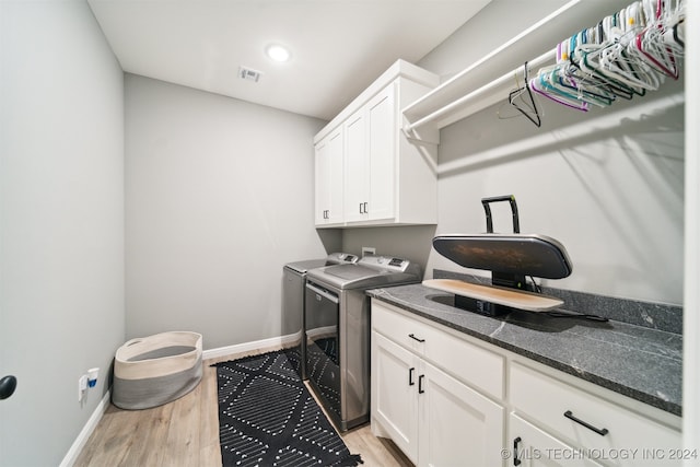 washroom with cabinets, light wood-type flooring, and independent washer and dryer