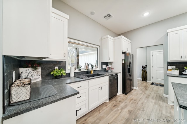 kitchen with decorative backsplash, light wood-type flooring, sink, black appliances, and white cabinets