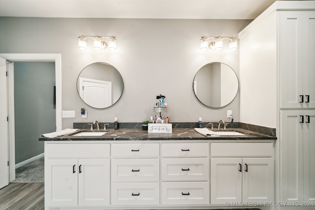 bathroom with hardwood / wood-style floors and vanity