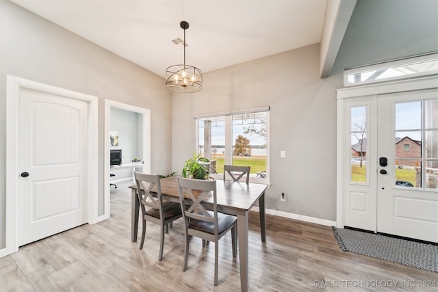 dining space with a chandelier and light hardwood / wood-style flooring