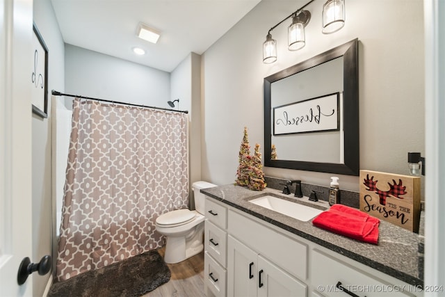 bathroom featuring hardwood / wood-style floors, vanity, toilet, and a shower with curtain