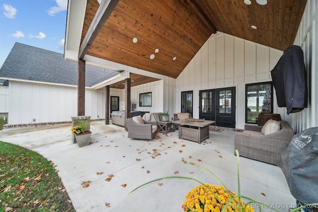 exterior space featuring french doors and an outdoor living space with a fire pit