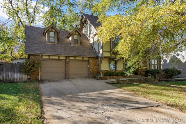 view of front of property with a front lawn and a garage