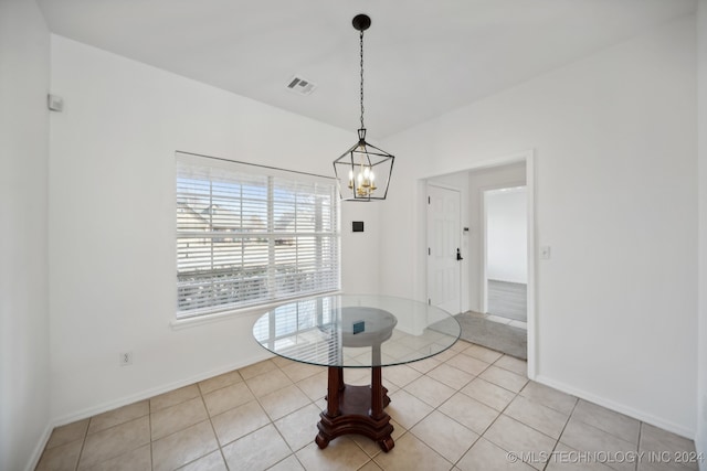 dining area with light tile patterned floors, visible vents, baseboards, and an inviting chandelier