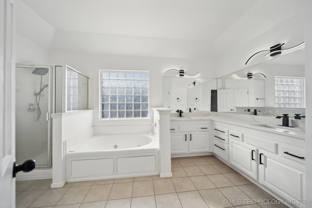 full bathroom featuring tile patterned flooring, a shower stall, a jetted tub, double vanity, and a sink