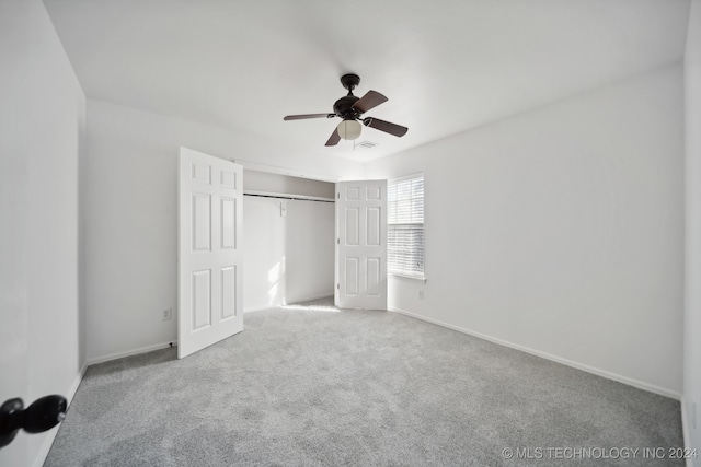 unfurnished bedroom featuring visible vents, baseboards, carpet floors, a closet, and a ceiling fan