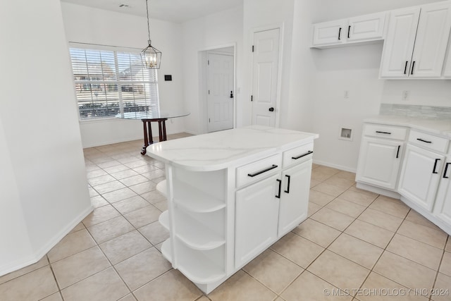 kitchen with open shelves, light tile patterned floors, light stone countertops, and pendant lighting