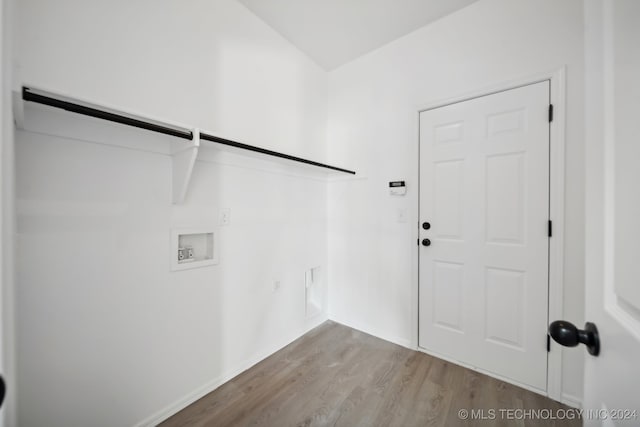 laundry area with laundry area, wood finished floors, gas dryer hookup, and washer hookup