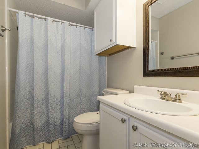 bathroom with curtained shower, toilet, tile patterned flooring, and vanity
