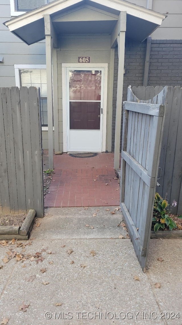 view of exterior entry featuring fence