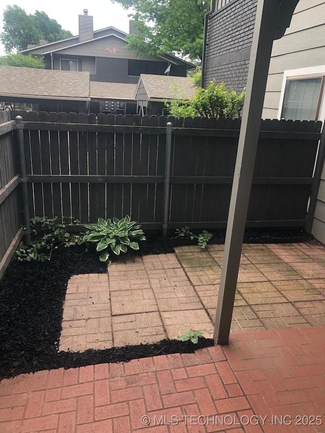view of patio featuring fence