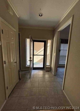 hallway with tile patterned flooring and crown molding