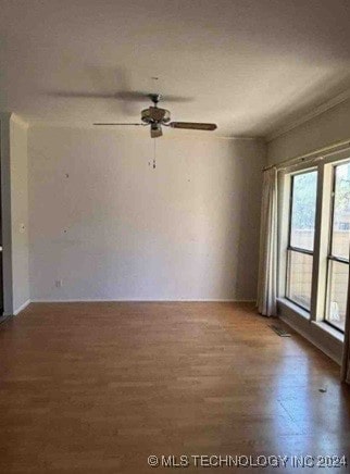 spare room with ceiling fan, dark hardwood / wood-style floors, and ornamental molding