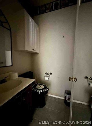 bathroom featuring tile patterned floors, vanity, and toilet