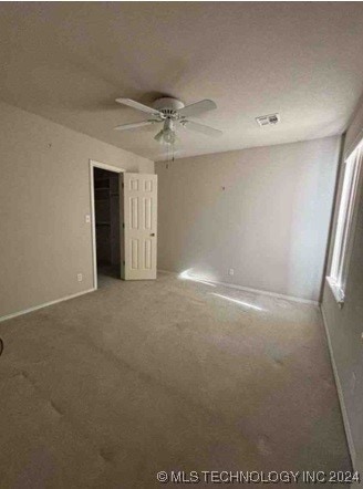 unfurnished bedroom with carpet flooring, ceiling fan, and a closet