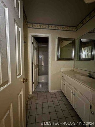 bathroom featuring tile patterned flooring and vanity