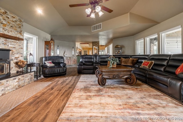 living room with ceiling fan, hardwood / wood-style floors, and vaulted ceiling