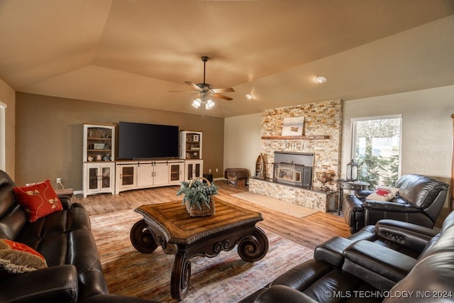 living room with a fireplace, light hardwood / wood-style floors, ceiling fan, and lofted ceiling