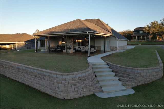 rear view of property with a yard and a patio