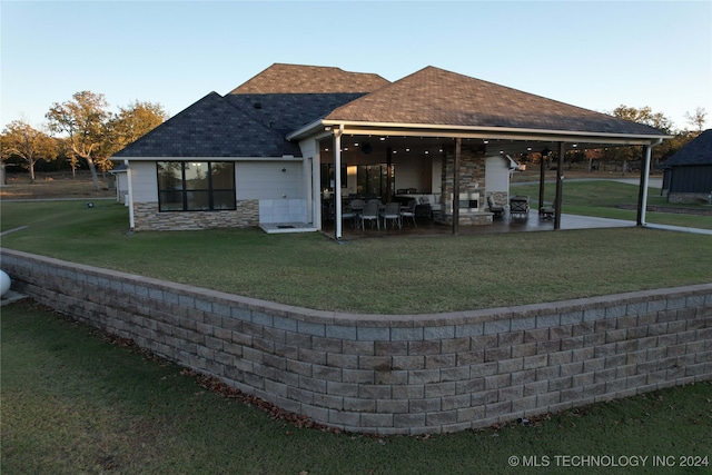 rear view of property featuring a yard and a patio