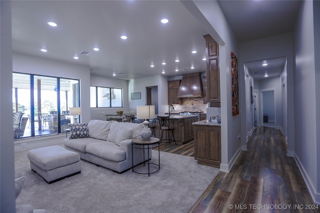 living room with dark hardwood / wood-style floors and sink