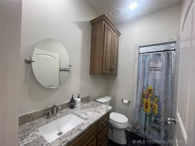 bathroom with a shower with shower curtain, vanity, and toilet