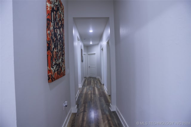 hallway with dark hardwood / wood-style flooring