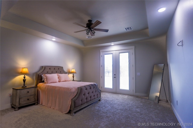 bedroom with carpet, french doors, ceiling fan, access to exterior, and a tray ceiling