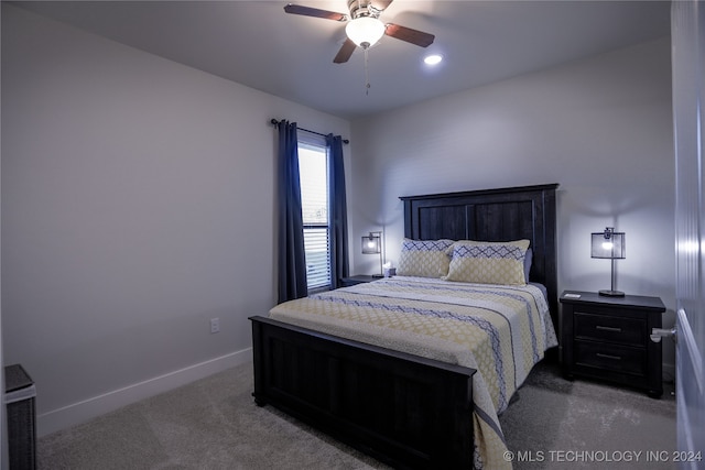 bedroom featuring dark carpet and ceiling fan