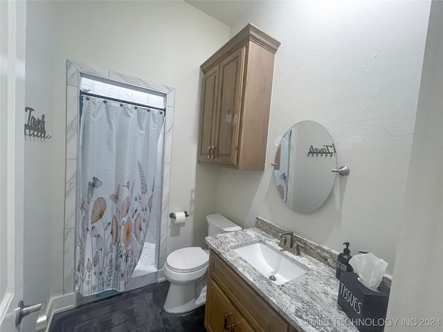 bathroom with a shower with curtain, vanity, and toilet