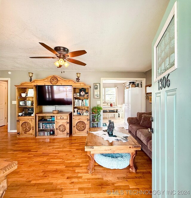 1306 E Comanche Ave, Mcalester, OK 74501 - living area with a ceiling fan, wood finished floors, and a textured ceiling
