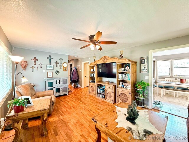 1306 E Comanche Ave, Mcalester, OK 74501 - living area with plenty of natural light, light wood-type flooring, a ceiling fan, and a textured ceiling
