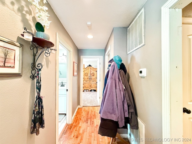 corridor with light hardwood / wood-style flooring