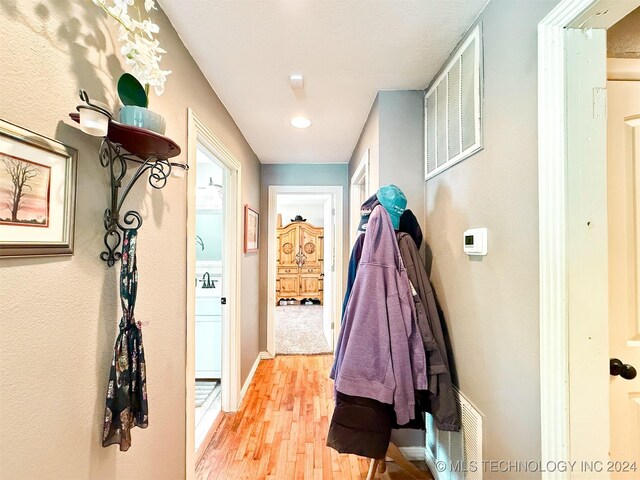 1306 E Comanche Ave, Mcalester, OK 74501 - corridor featuring light wood-type flooring and baseboards