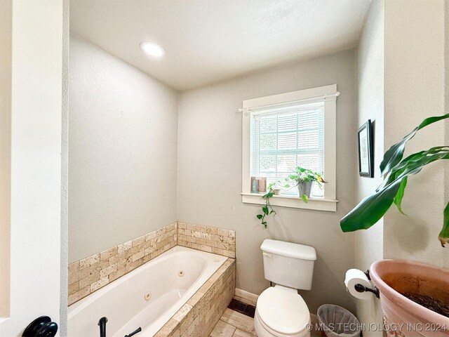 1306 E Comanche Ave, Mcalester, OK 74501 - full bathroom with toilet, a whirlpool tub, and baseboards