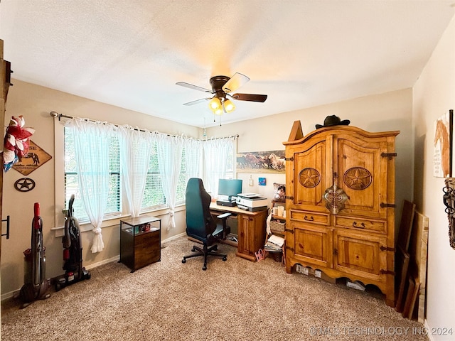 carpeted home office with ceiling fan and a textured ceiling