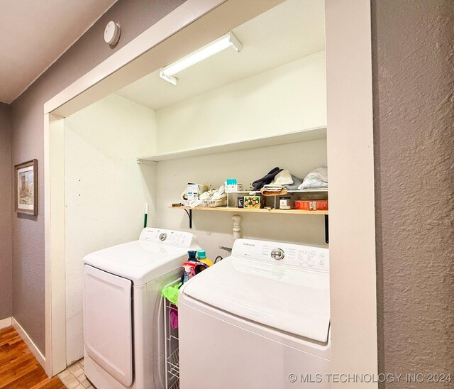 1306 E Comanche Ave, Mcalester, OK 74501 - washroom with washing machine and clothes dryer, light wood finished floors, and baseboards