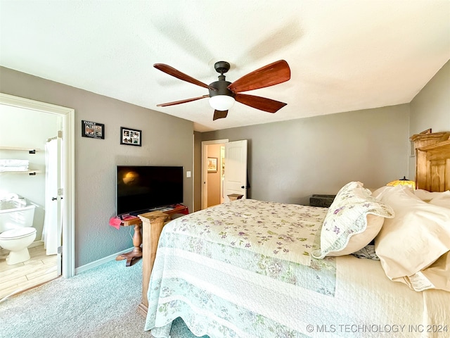 carpeted bedroom with ceiling fan and connected bathroom