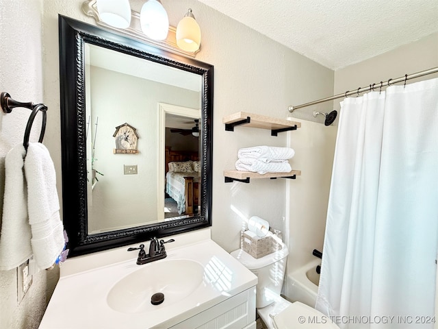 full bathroom featuring toilet, vanity, a textured ceiling, and shower / tub combo with curtain