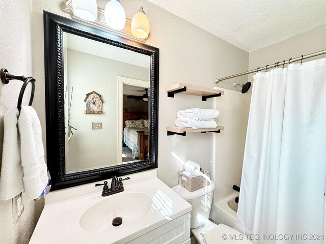 1306 E Comanche Ave, Mcalester, OK 74501 - full bathroom featuring vanity, shower / bathtub combination with curtain, toilet, a textured ceiling, and ceiling fan