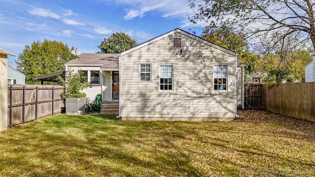 back of property with a lawn and central air condition unit